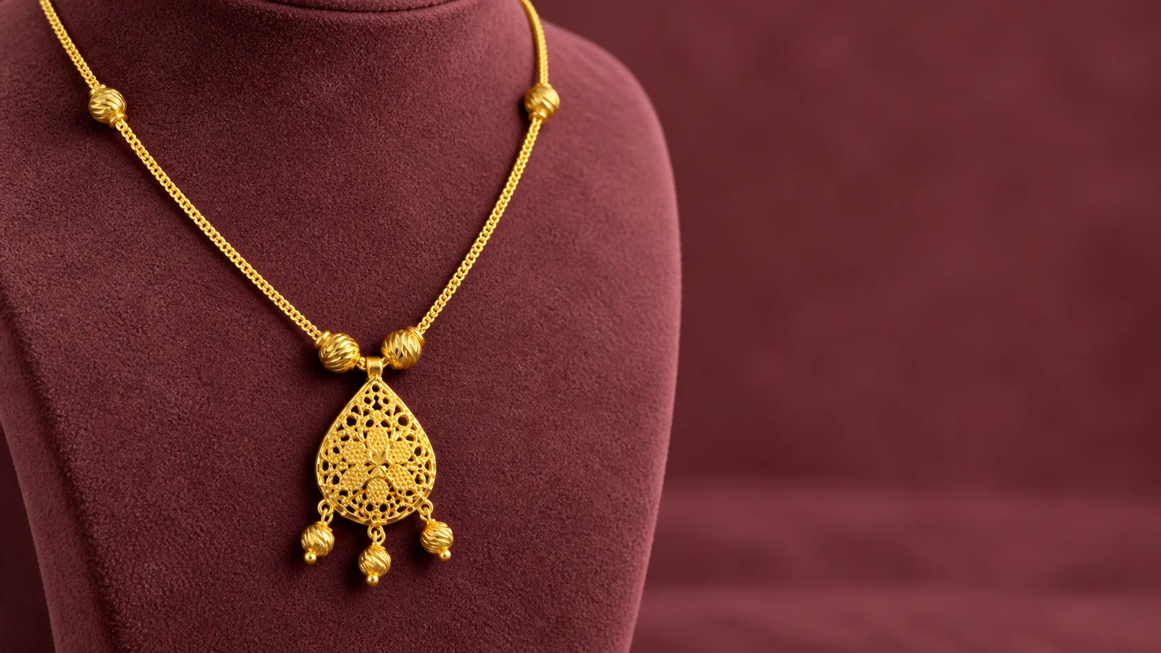 AI-created catalogue-inspired gold floral pendant necklace on a burgundy display