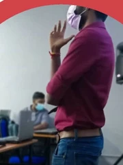 A facilitator speaking to participants in a training room.